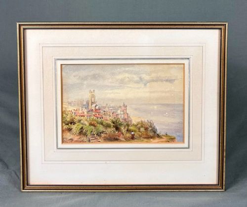 fig 5. A 19th-century watercolour landscape illustrating a coastal town with a church tower, red-roofed buildings, a grassy cliff path, and a serene sea view.