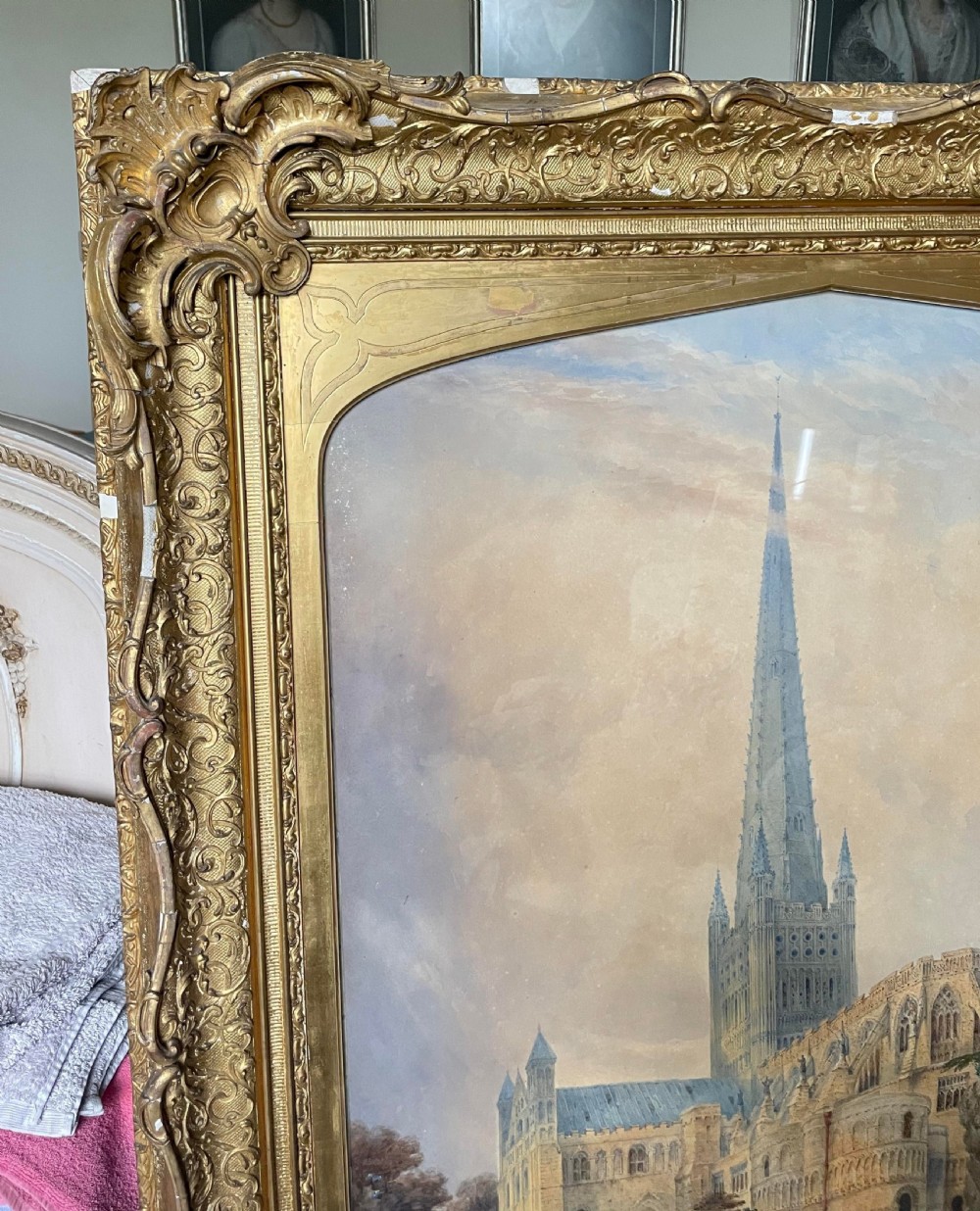 A nineteenth-century watercolour painting depicting Norwich Cathedral with a detailed spire, flying buttresses, and figures on the surrounding lawn. View X