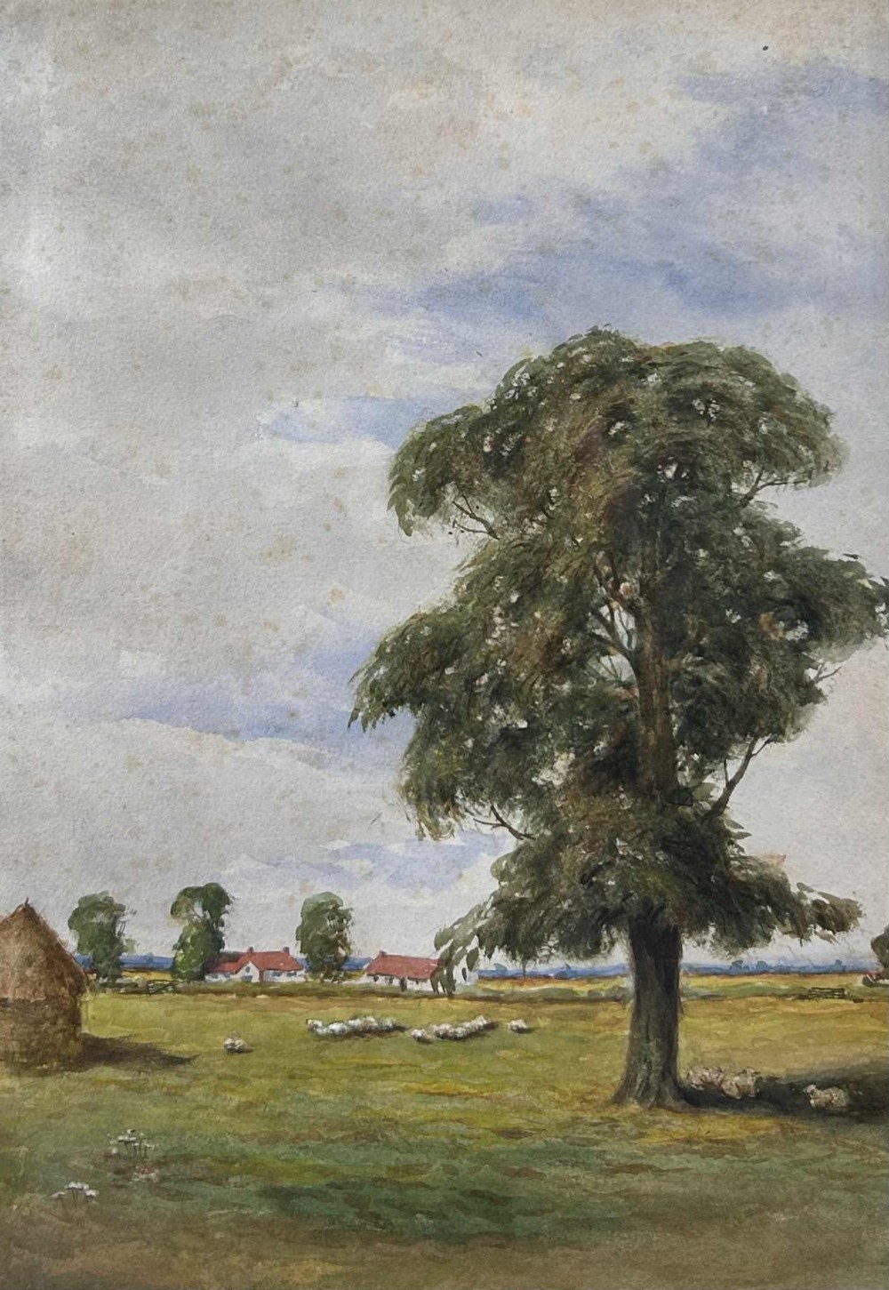 An antique watercolour painting depicting a prominent leafy green tree in a pastoral field with grazing sheep and distant red-roofed cottages under a light blue sky.