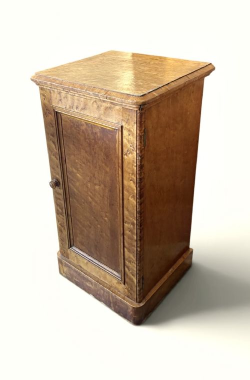 A 19th-century birds eye maple pedestal cupboard featuring a panelled door, turned wooden knob, and plinth base. View II