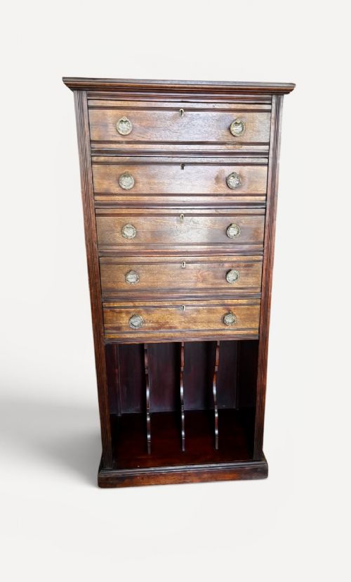 An early 20th-century tall and narrow mahogany chest featuring five drawers over an open lower section with vertical dividers. View IV