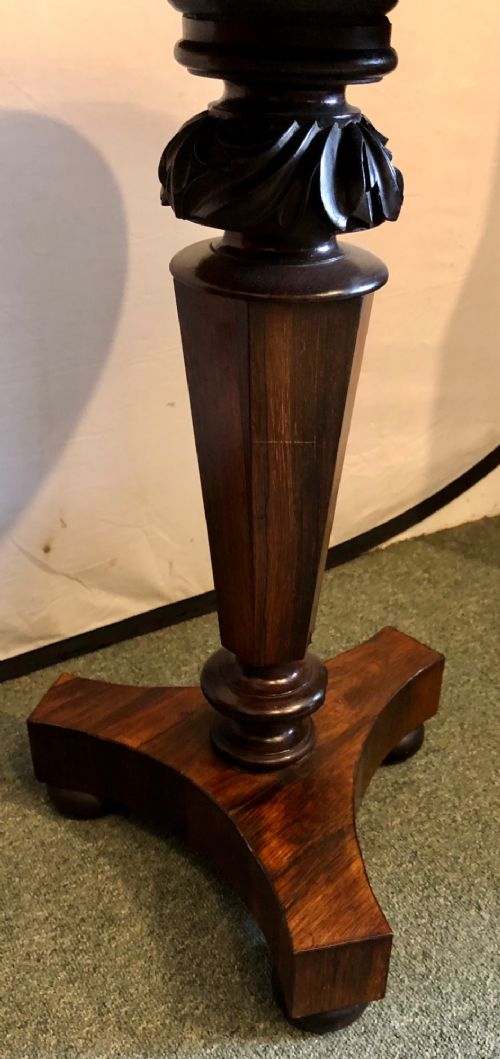 A Victorian rosewood wine table with a round top resting on a central column and a triform base. View III