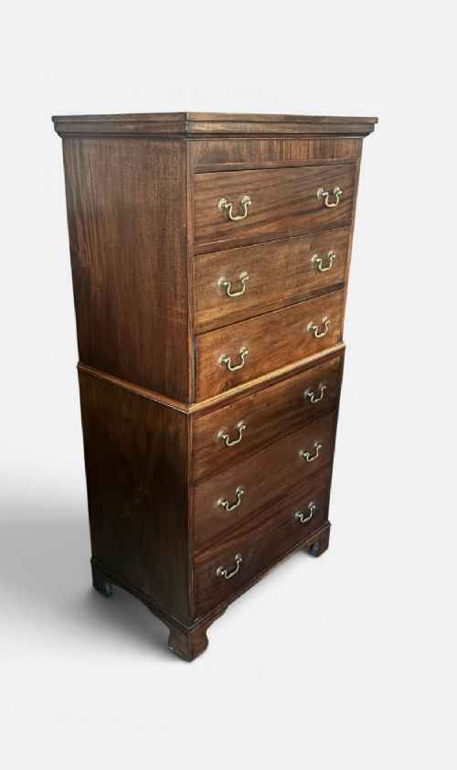 An early 20th century mahogany tallboy chest featuring six graduated drawers with brass drop handles and bracket feet. View III