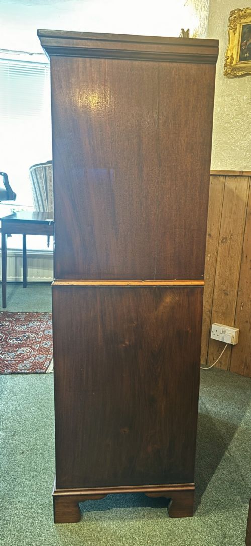 An early 20th century mahogany tallboy chest featuring six graduated drawers with brass drop handles and bracket feet. View V