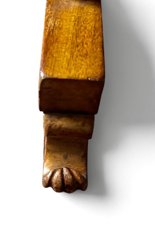 An English Regency mahogany writing table with a polished rectangular top, trestle side supports, turned central stretcher, and carved feet. View VI