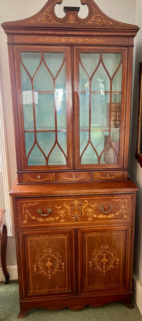 An Edwardian mahogany secretaire bookcase featuring satinwood marquetry inlays, a swan-neck pediment, glazed upper doors, and a pull-out desk drawer above lower cupboards. View III