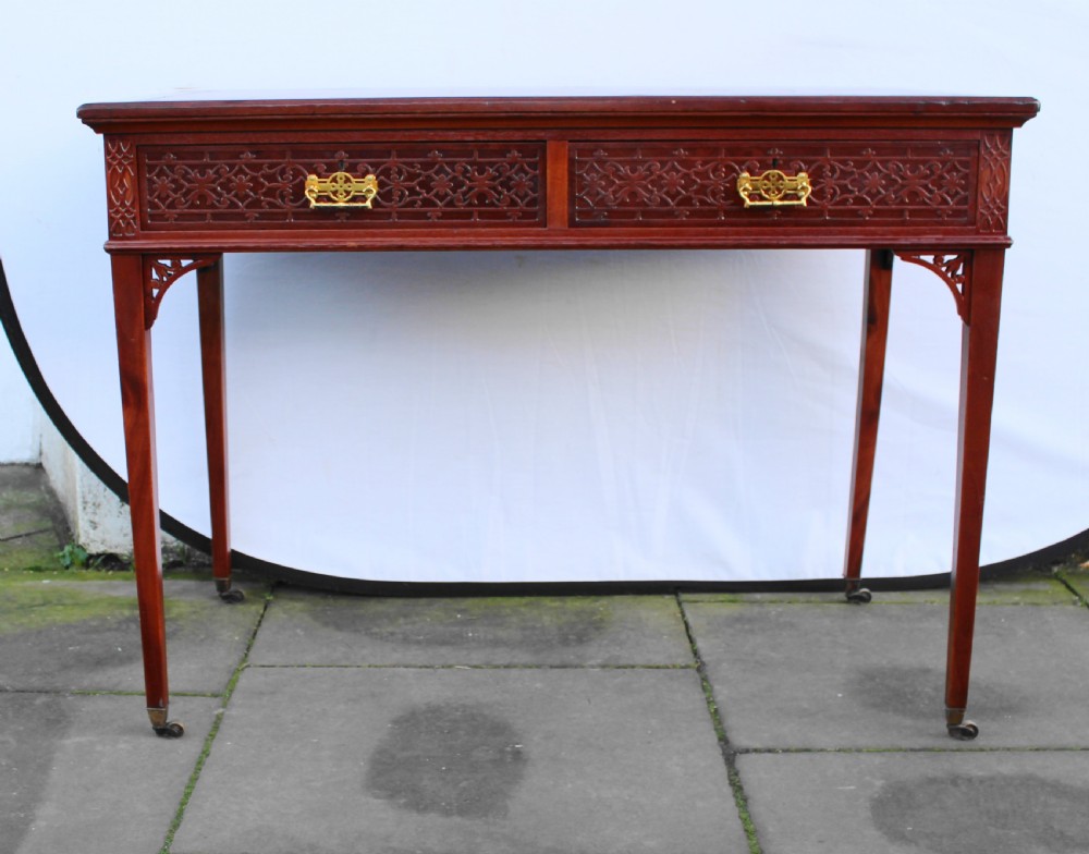 Victorian mahogany side/writing table with blind fret carving View VIII