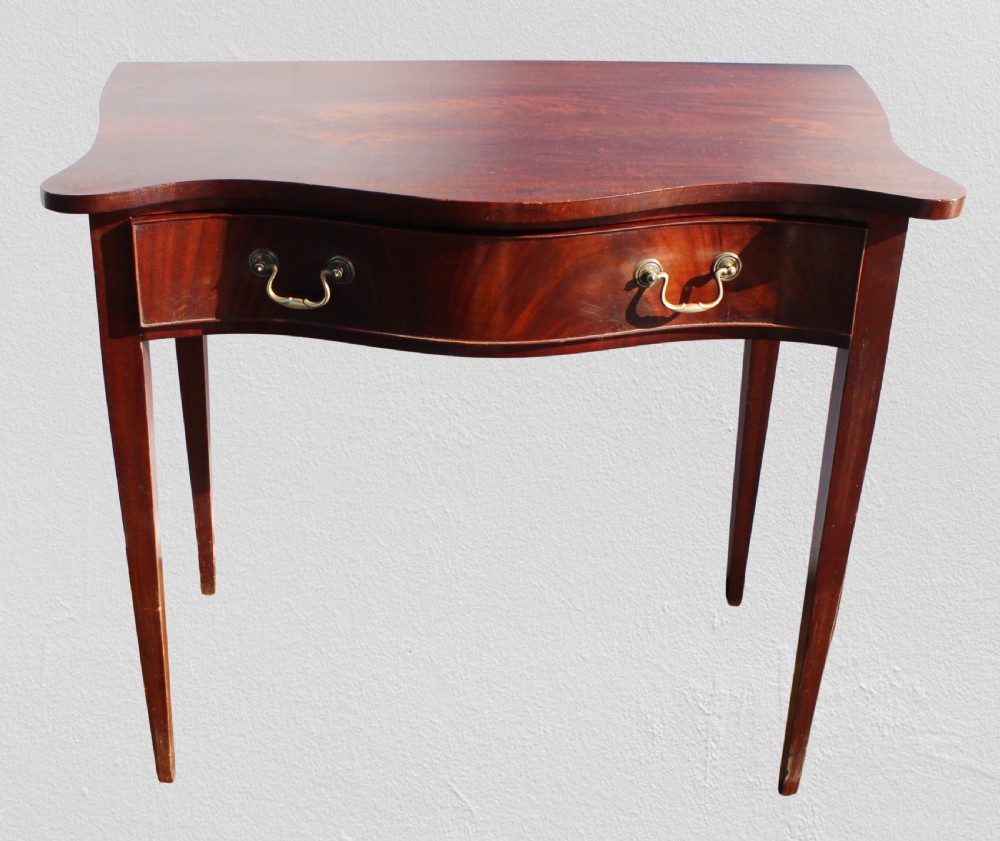19th century figured mahogany serpentine side table