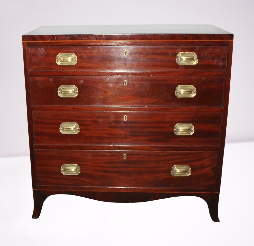 A Regency figured mahogany chest of four graduated drawers featuring brass handles and splayed bracket feet.