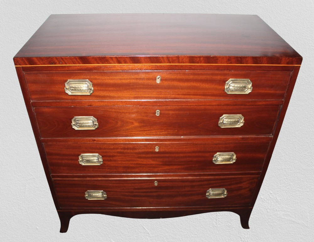 A Regency figured mahogany chest of four graduated drawers featuring brass handles and splayed bracket feet. View II