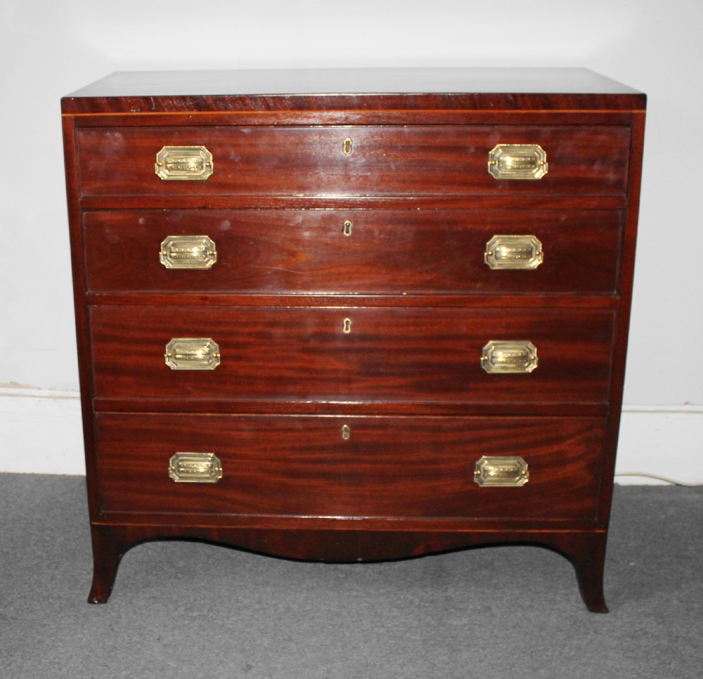 A Regency figured mahogany chest of four graduated drawers featuring brass handles and splayed bracket feet. View III