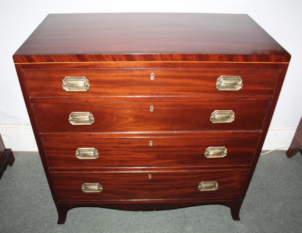 A Regency figured mahogany chest of four graduated drawers featuring brass handles and splayed bracket feet. View V