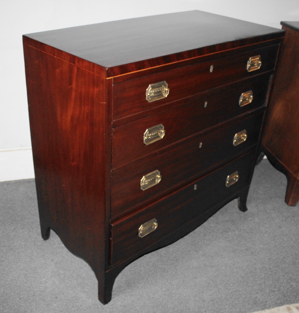 A Regency figured mahogany chest of four graduated drawers featuring brass handles and splayed bracket feet. View X