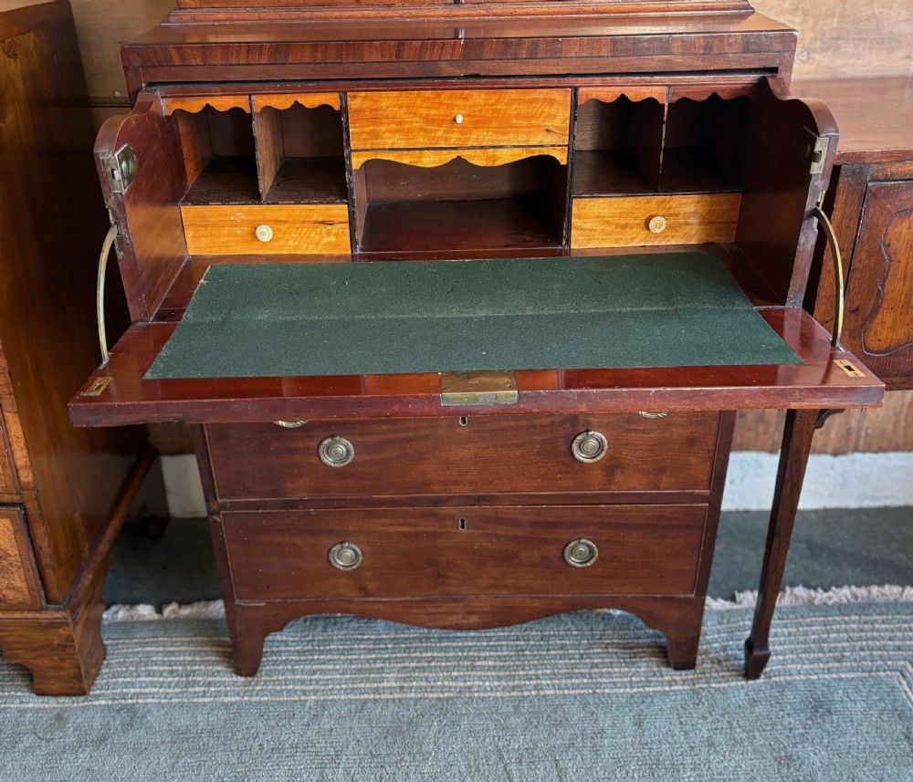 A Regency mahogany secretaire bookcase featuring glazed double doors with geometric astragal glazing above a chest of drawers with brass ring handles. View XIII