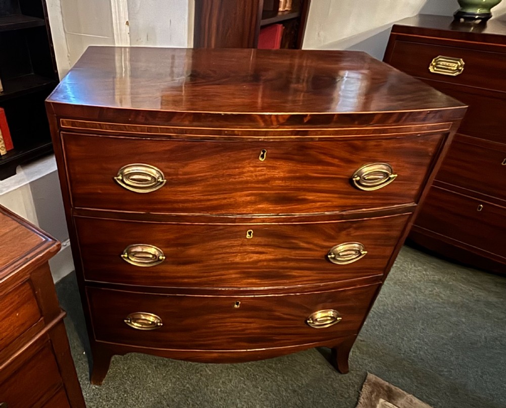 Small Regency figured mahogany bow front chest of drawers View IX