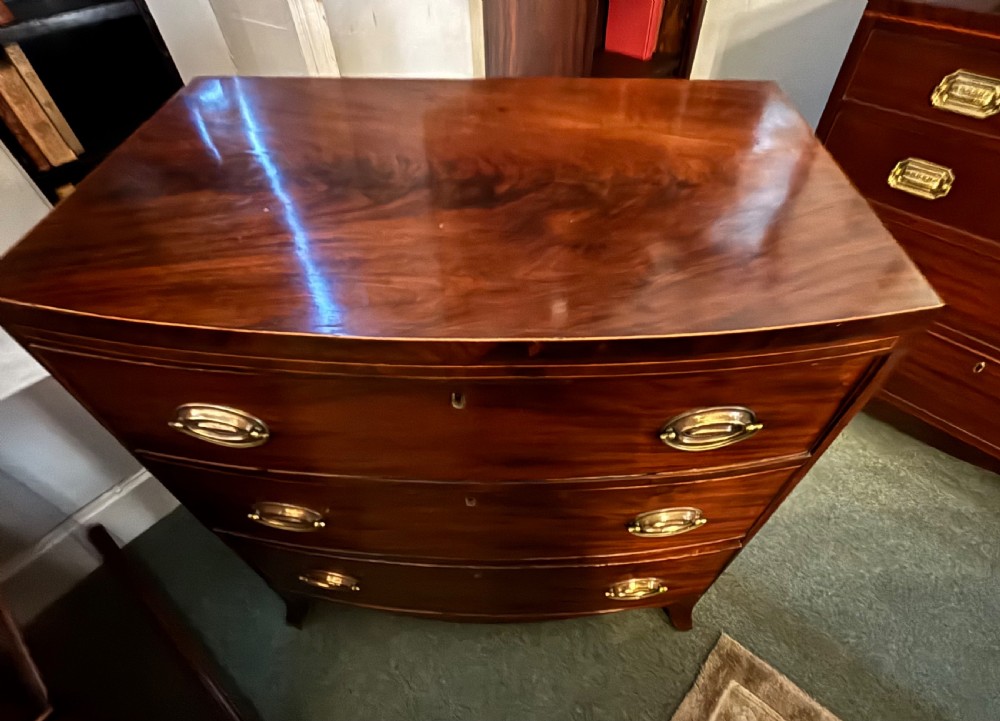 Small Regency figured mahogany bow front chest of drawers View XI