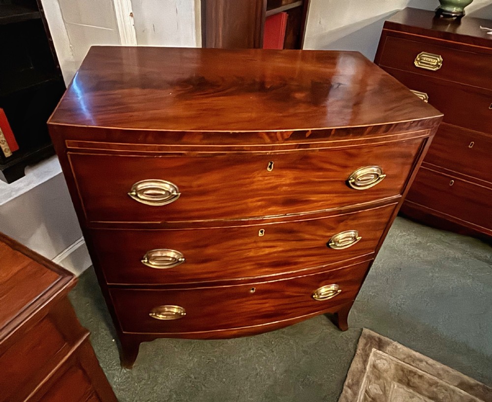 Small Regency figured mahogany bow front chest of drawers View XII