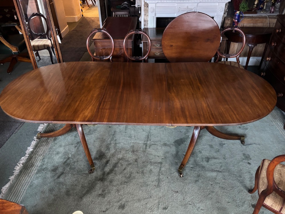 Fine quality 19th century figured mahogany Regency design twin pillar dining table View IV