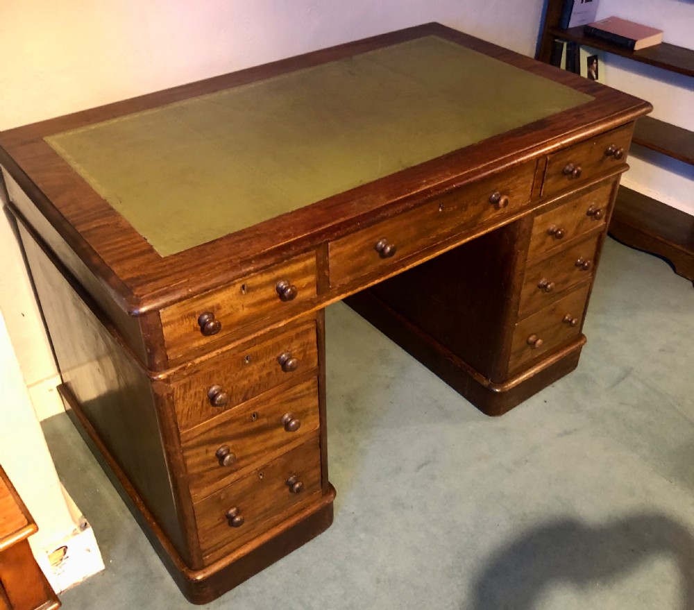 Victorian mahogany pedestal desk with green leather top