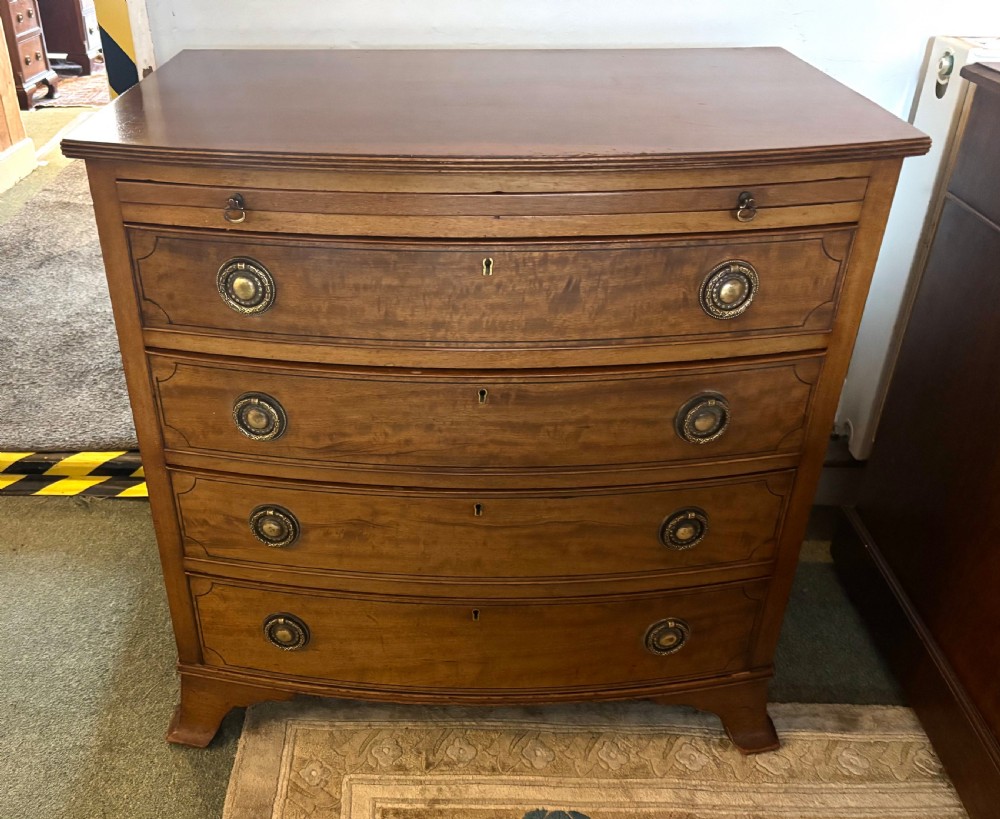Small Edwardian mahogany and ebony inlaid bow front chest of drawers with brushing slide View IV