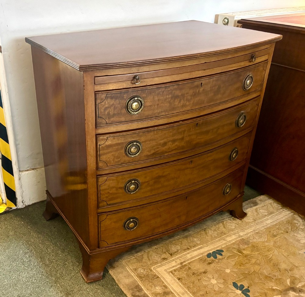 Small Edwardian mahogany and ebony inlaid bow front chest of drawers with brushing slide View V