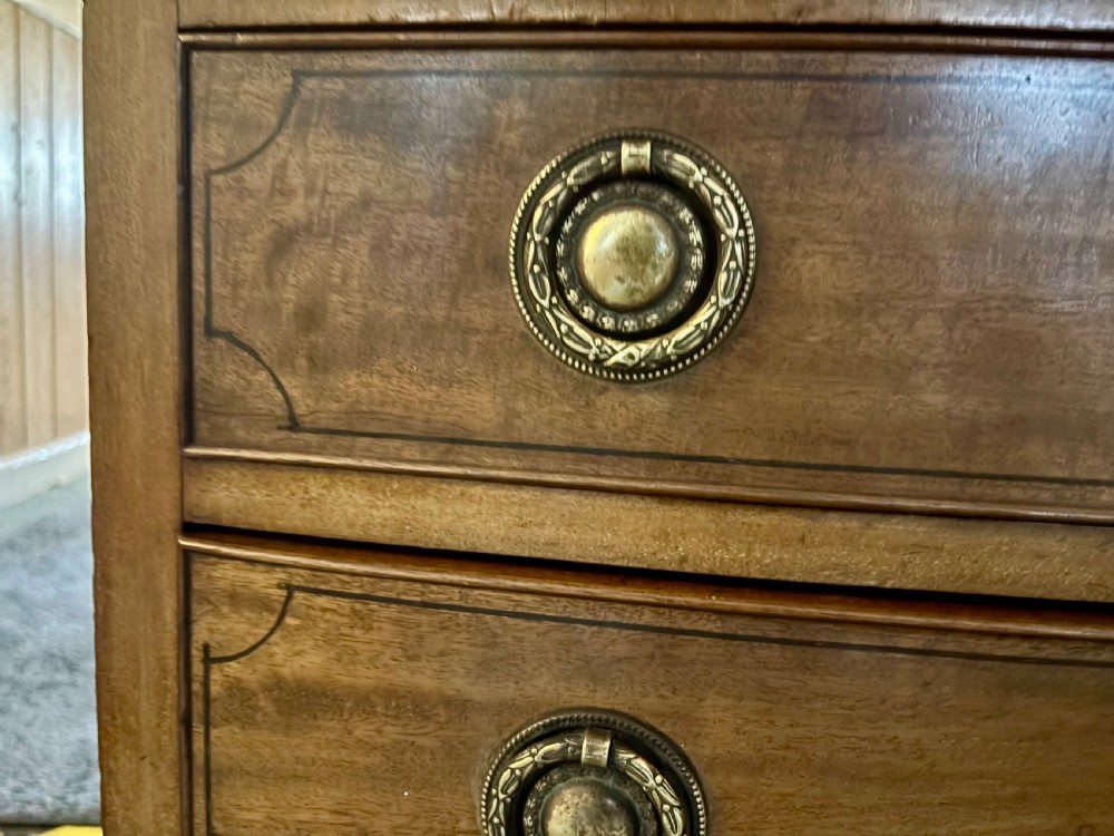 Small Edwardian mahogany and ebony inlaid bow front chest of drawers with brushing slide View IX