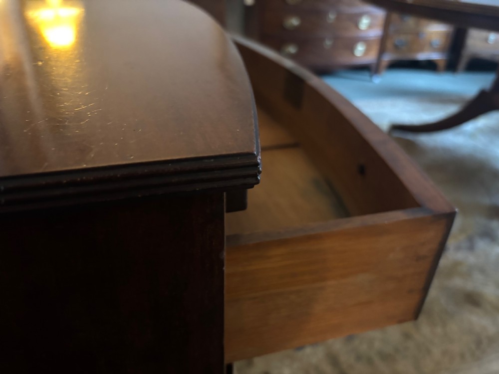 Small Edwardian mahogany and ebony inlaid bow front chest of drawers with brushing slide View X