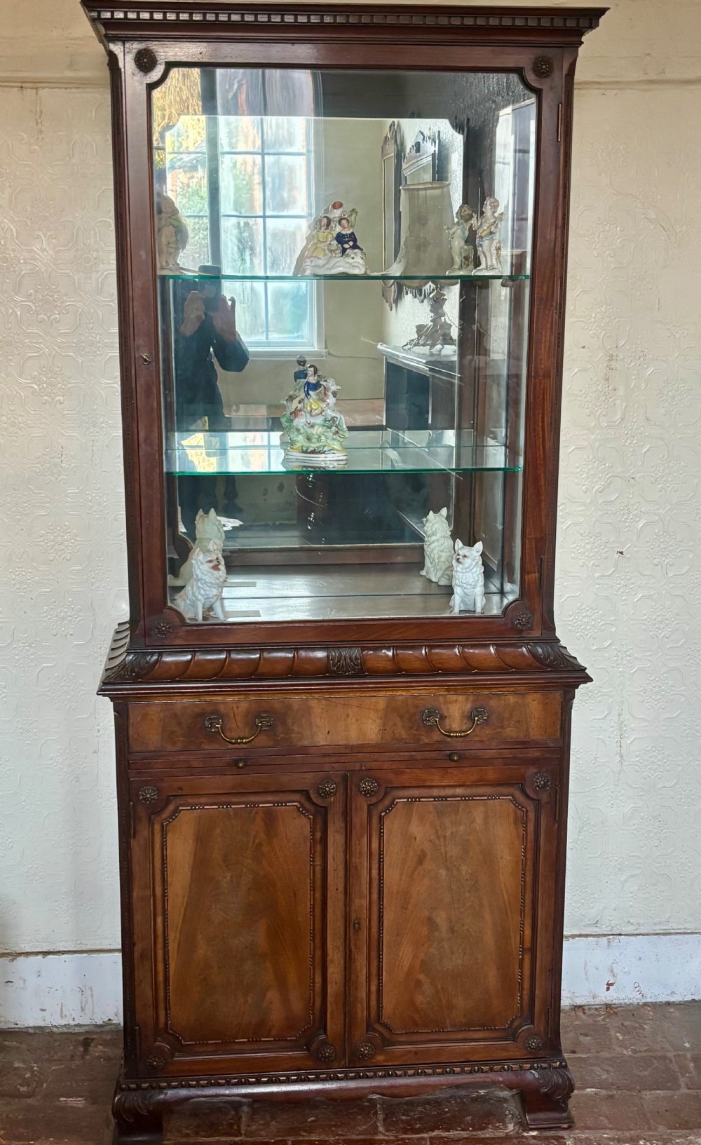 An early twentieth-century glazed mahogany display cabinet featuring an upper single glazed door section above a single drawer and double cupboard base. View IV