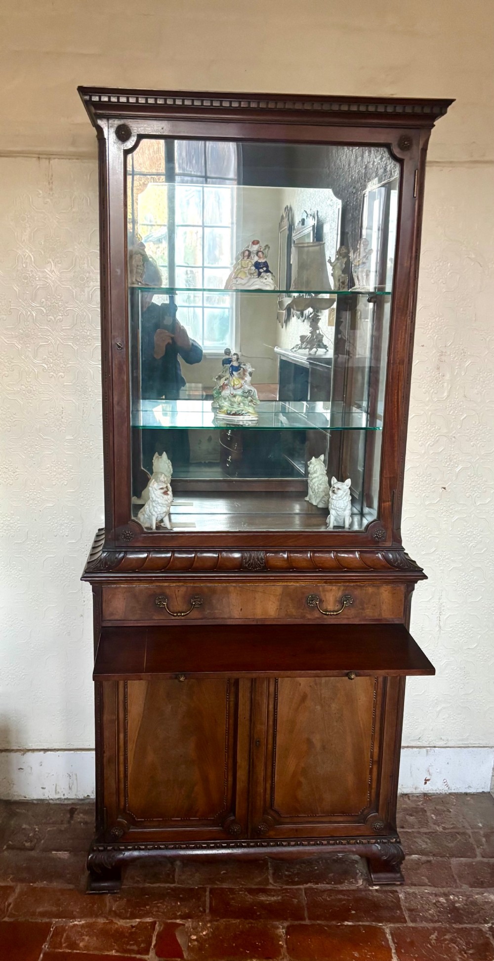 An early twentieth-century glazed mahogany display cabinet featuring an upper single glazed door section above a single drawer and double cupboard base. View IX