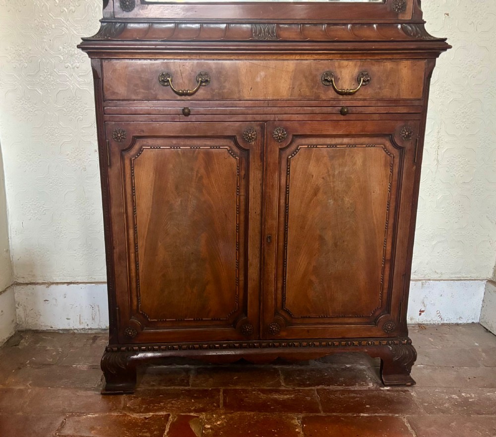 An early twentieth-century glazed mahogany display cabinet featuring an upper single glazed door section above a single drawer and double cupboard base. View X