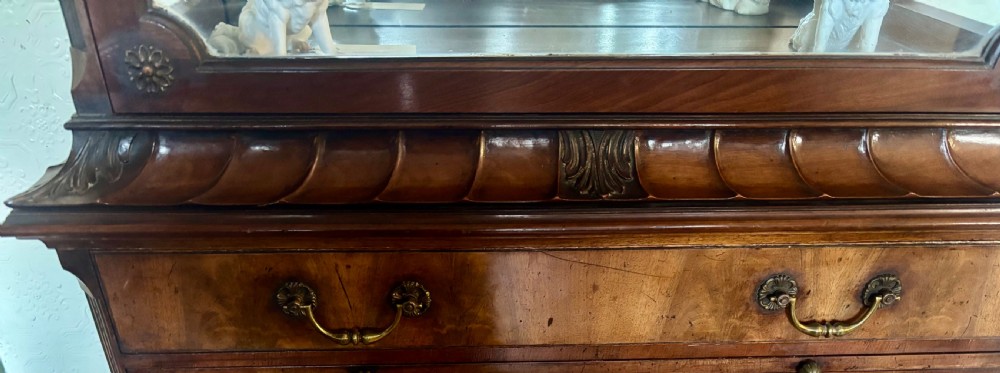 An early twentieth-century glazed mahogany display cabinet featuring an upper single glazed door section above a single drawer and double cupboard base. View XI
