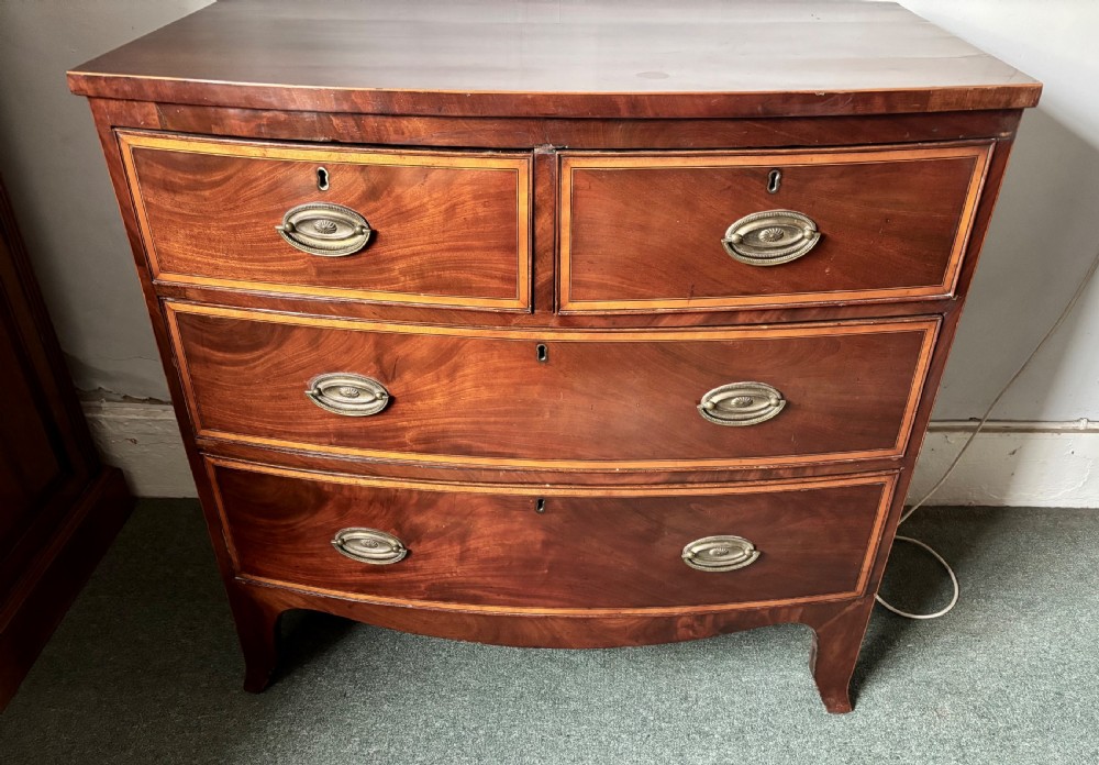 Regency figured mahogany and satinwood inlaid small bow front chest of drawers View IV