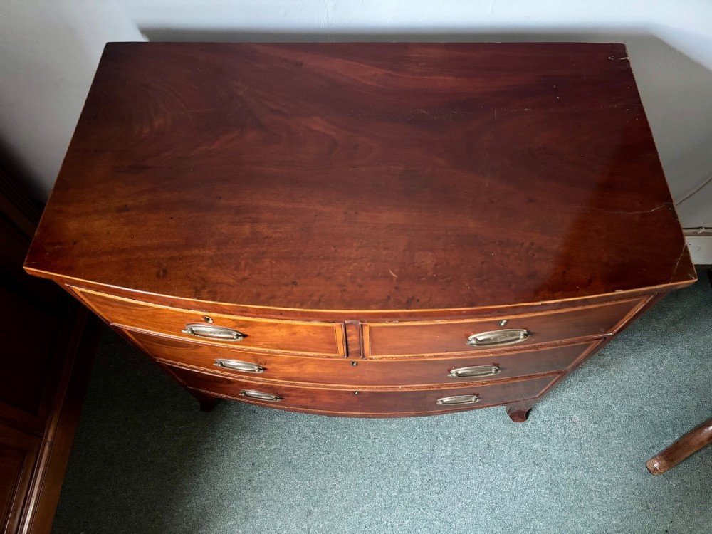 Regency figured mahogany and satinwood inlaid small bow front chest of drawers View V
