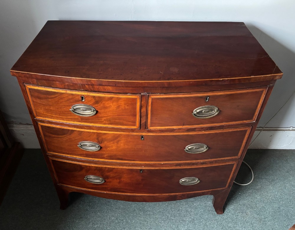 Regency figured mahogany and satinwood inlaid small bow front chest of drawers View VI