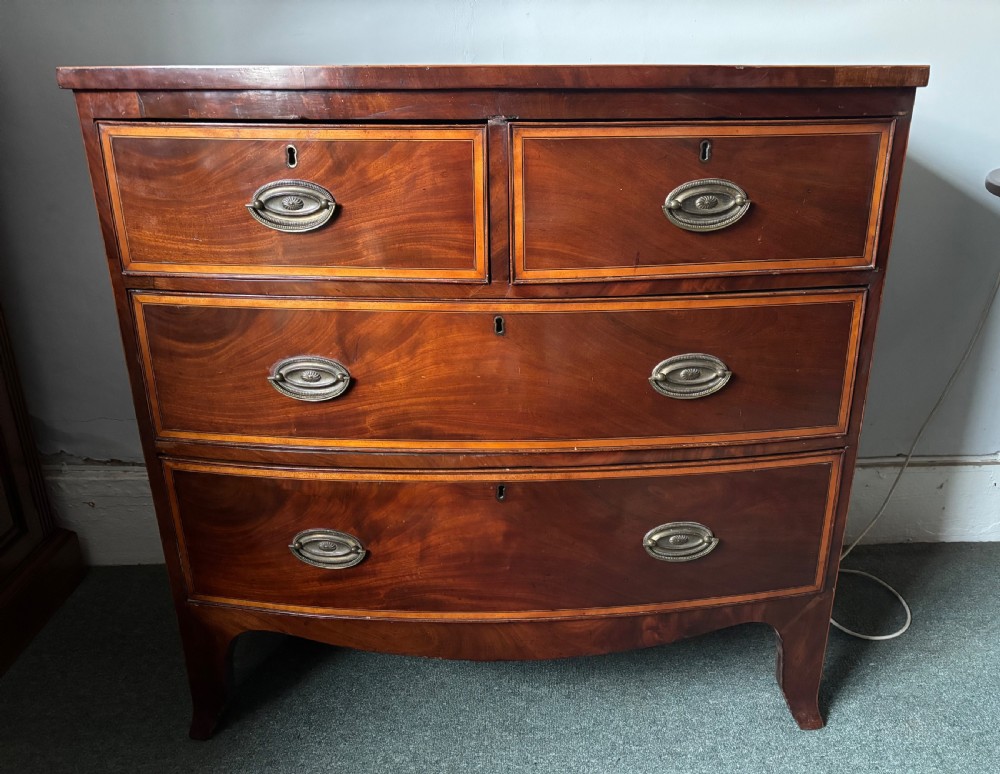 Regency figured mahogany and satinwood inlaid small bow front chest of drawers View VII