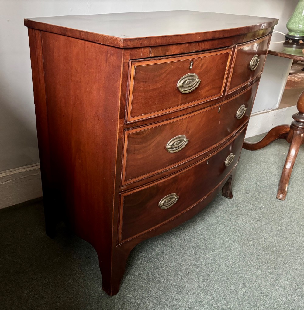 Regency figured mahogany and satinwood inlaid small bow front chest of drawers View VIII