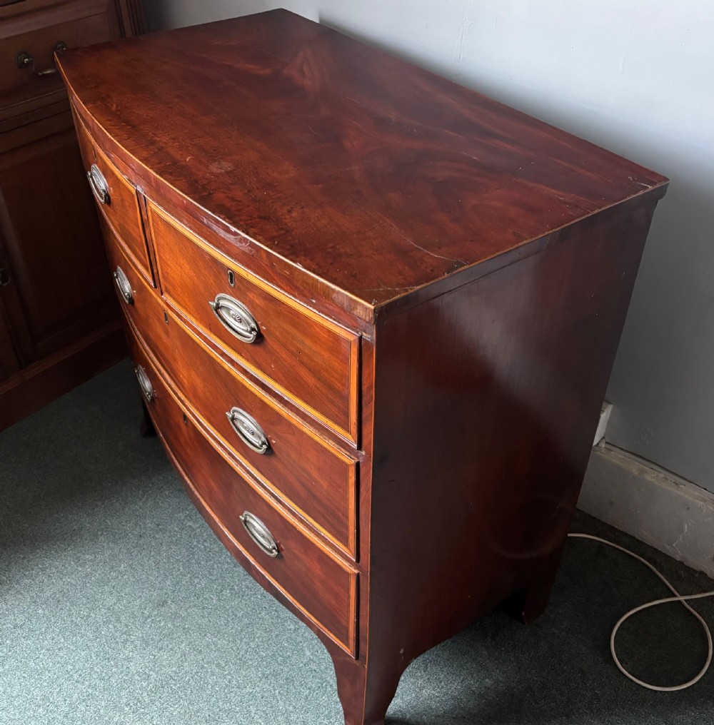 Regency figured mahogany and satinwood inlaid small bow front chest of drawers View IX