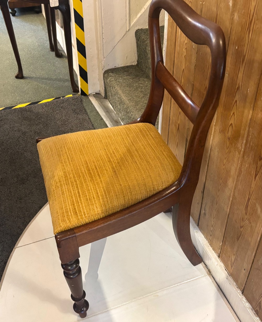 A set of six early Victorian balloon back dining chairs made of dark mahogany wood with mustard yellow textured seats. View IV