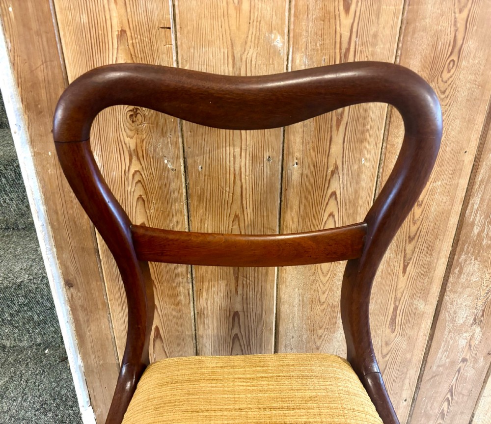 A set of six early Victorian balloon back dining chairs made of dark mahogany wood with mustard yellow textured seats. View IX