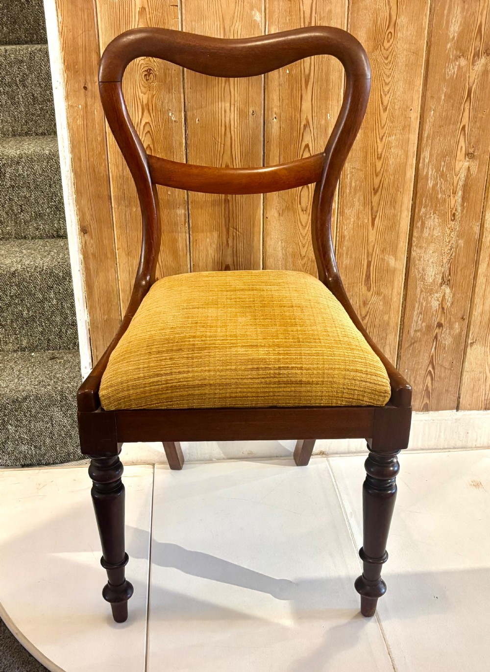 A set of six early Victorian balloon back dining chairs made of dark mahogany wood with mustard yellow textured seats. View X