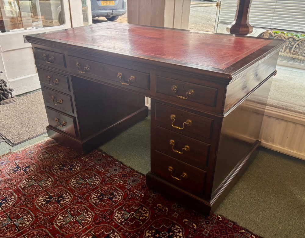 Large Edwardian mahogany pedestal desk with burgundy leather top