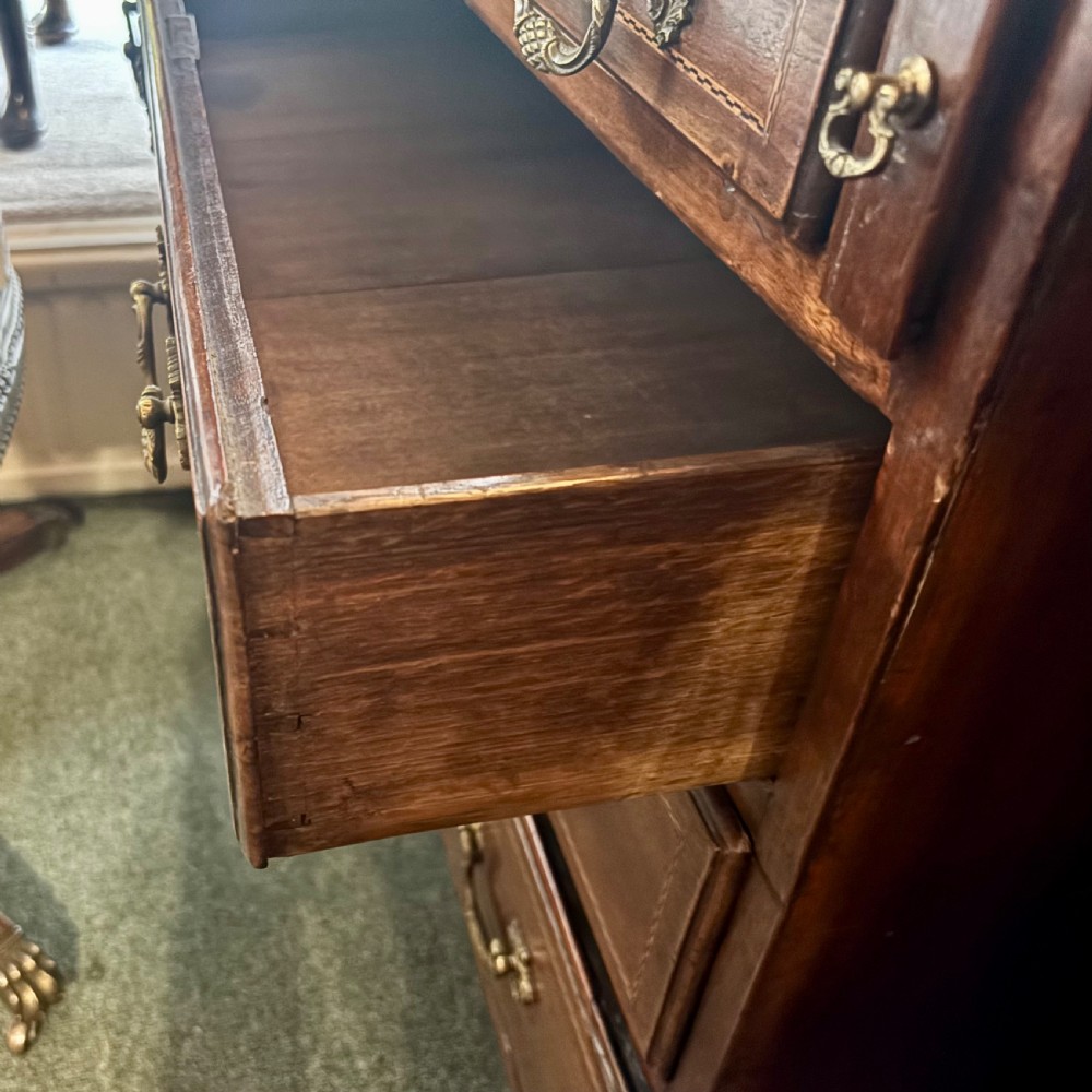 An 18th-century George III mahogany slant-front bureau featuring satinwood shell inlays and four graduating drawers with brass handles. View V