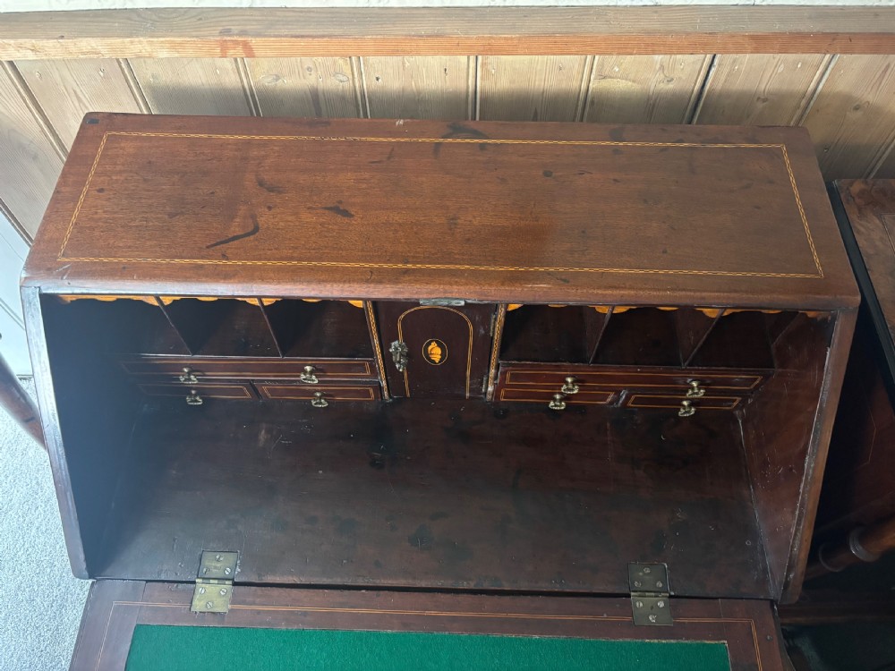 An 18th-century George III mahogany slant-front bureau featuring satinwood shell inlays and four graduating drawers with brass handles. View VI