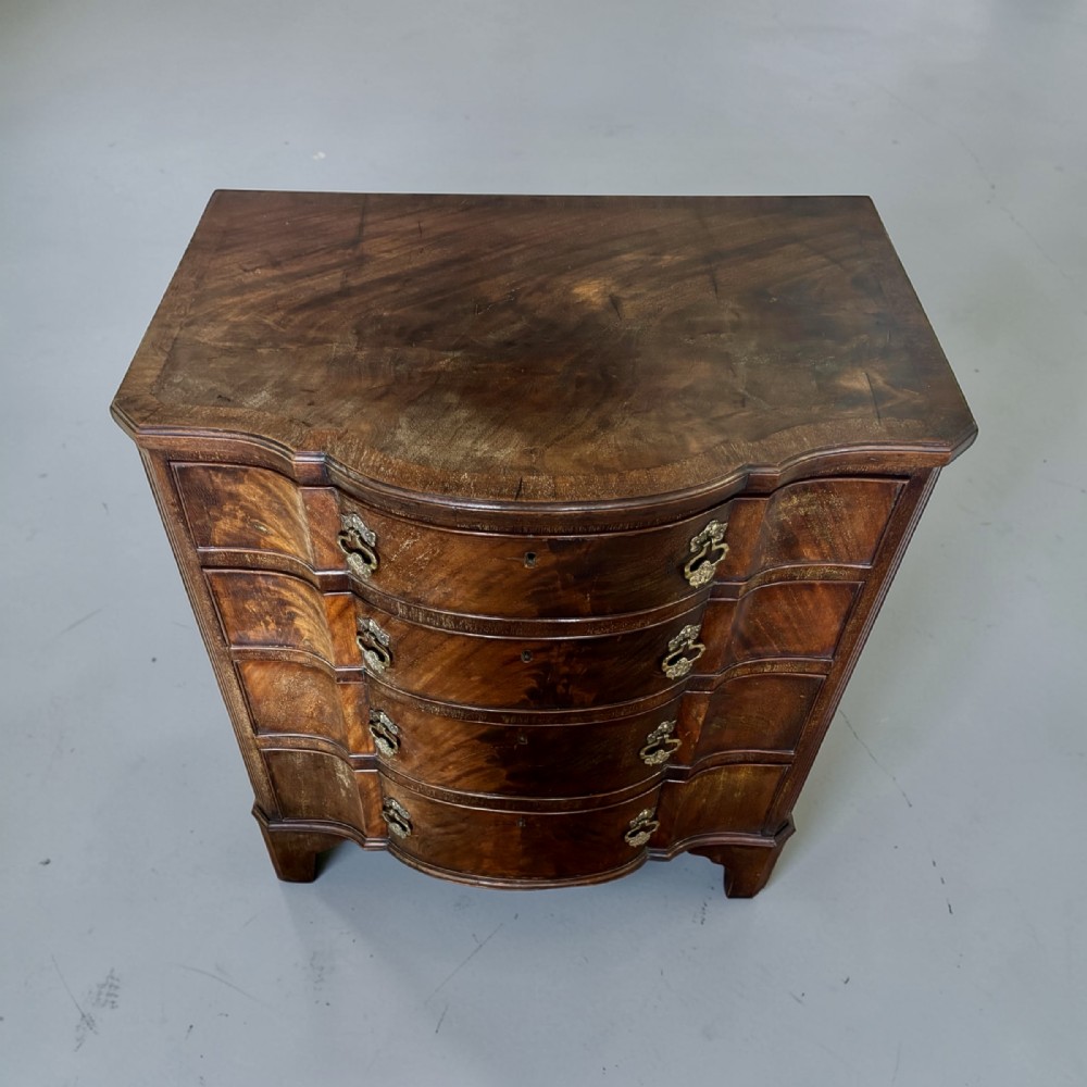 Edwardian small serpentine chest of drawers in well figured mahogany View II