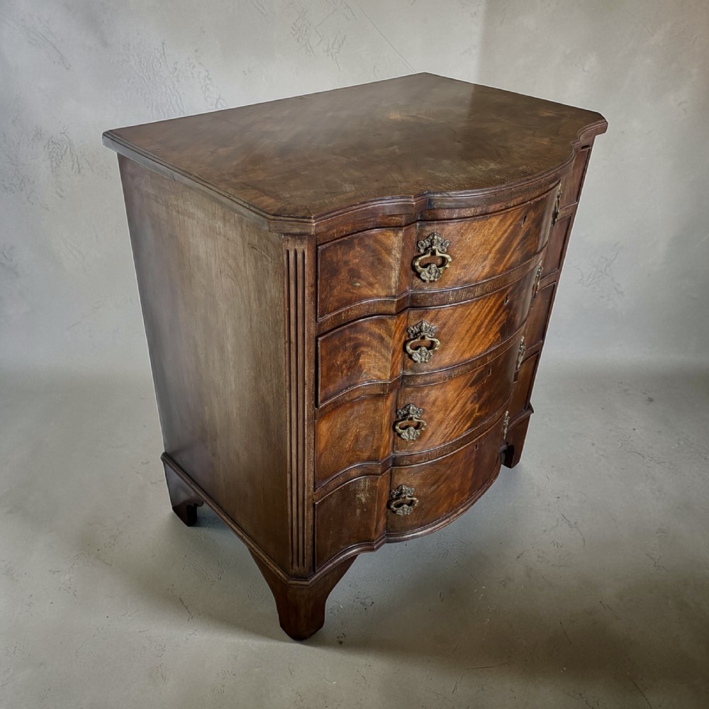Edwardian small serpentine chest of drawers in well figured mahogany View III