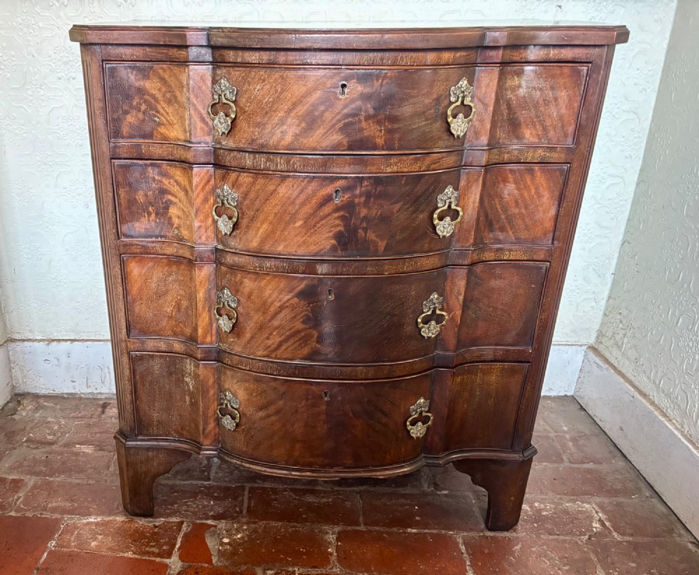 Edwardian small serpentine chest of drawers in well figured mahogany View X