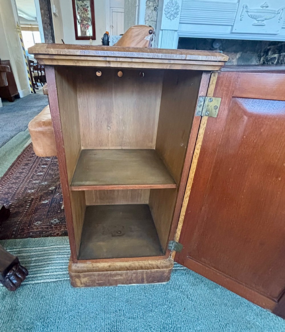 A 19th-century birds eye maple pedestal cupboard featuring a panelled door, turned wooden knob, and plinth base. View VI