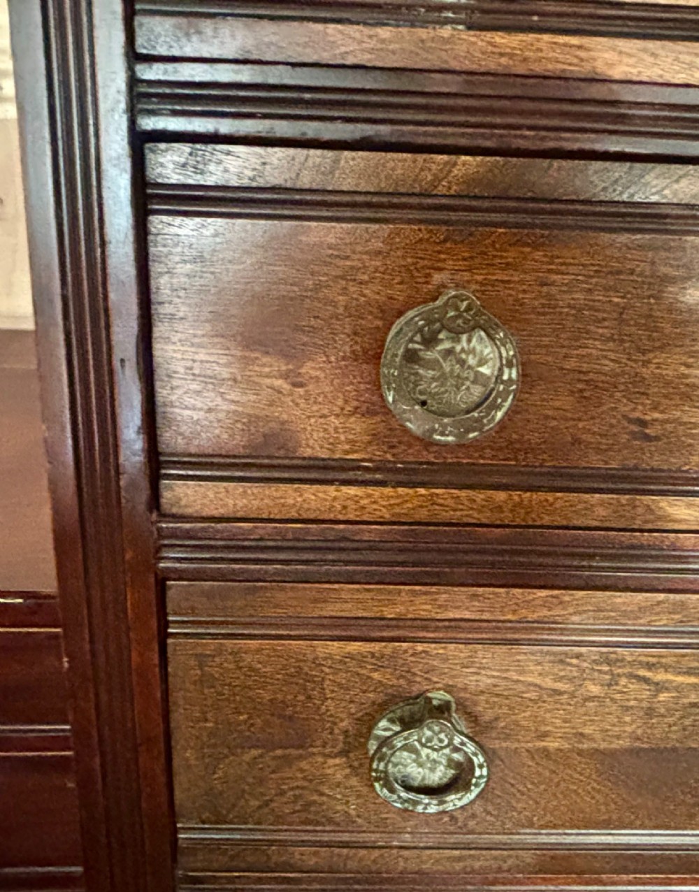 An early 20th-century tall and narrow mahogany chest featuring five drawers over an open lower section with vertical dividers. View VIII