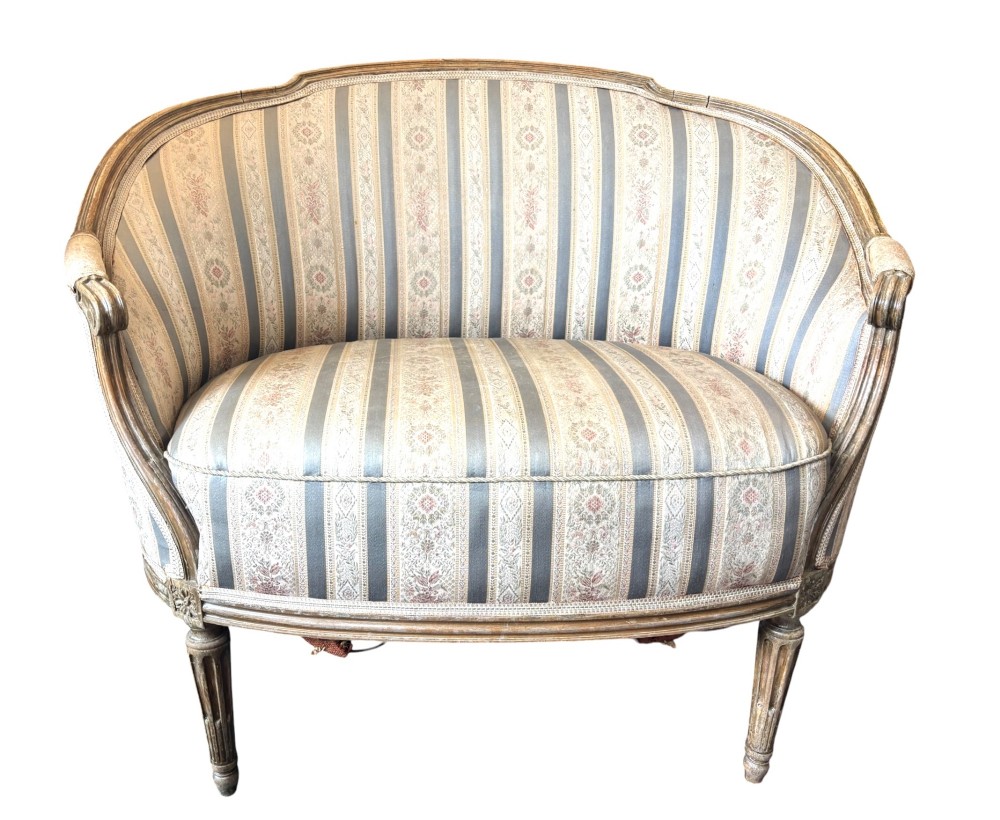 A Louis XVI style small settee featuring a curved barrel back, striped upholstery in grey and blue tones, and carved fluted legs. View III