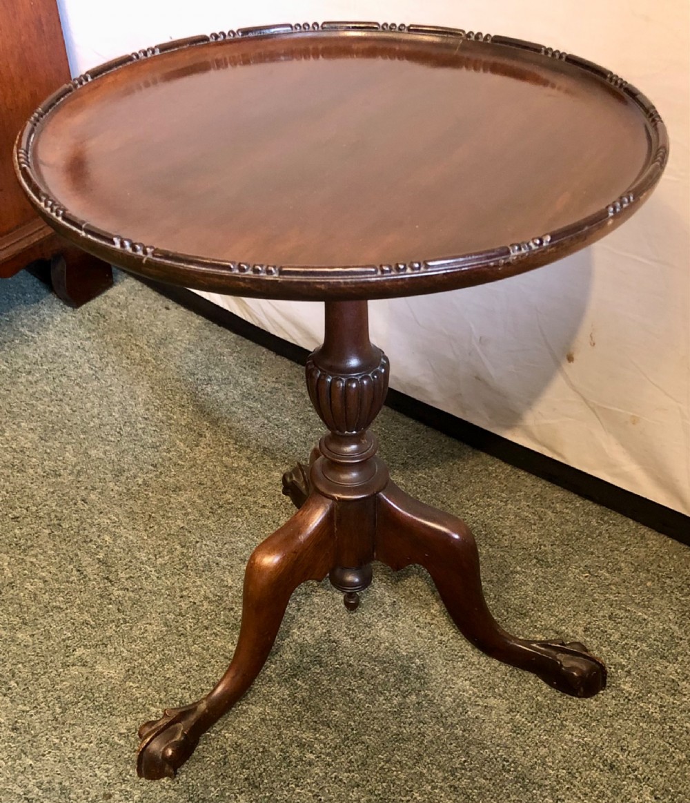 A small early twentieth-century mahogany tripod wine table featuring a circular top with a beaded rim, turned stem, and three cabriole legs. View III